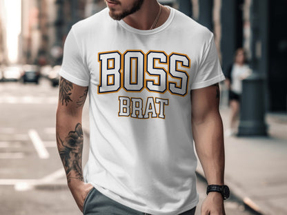White t-shirt with "BOSS BRAT" text in blue and gold block letters.