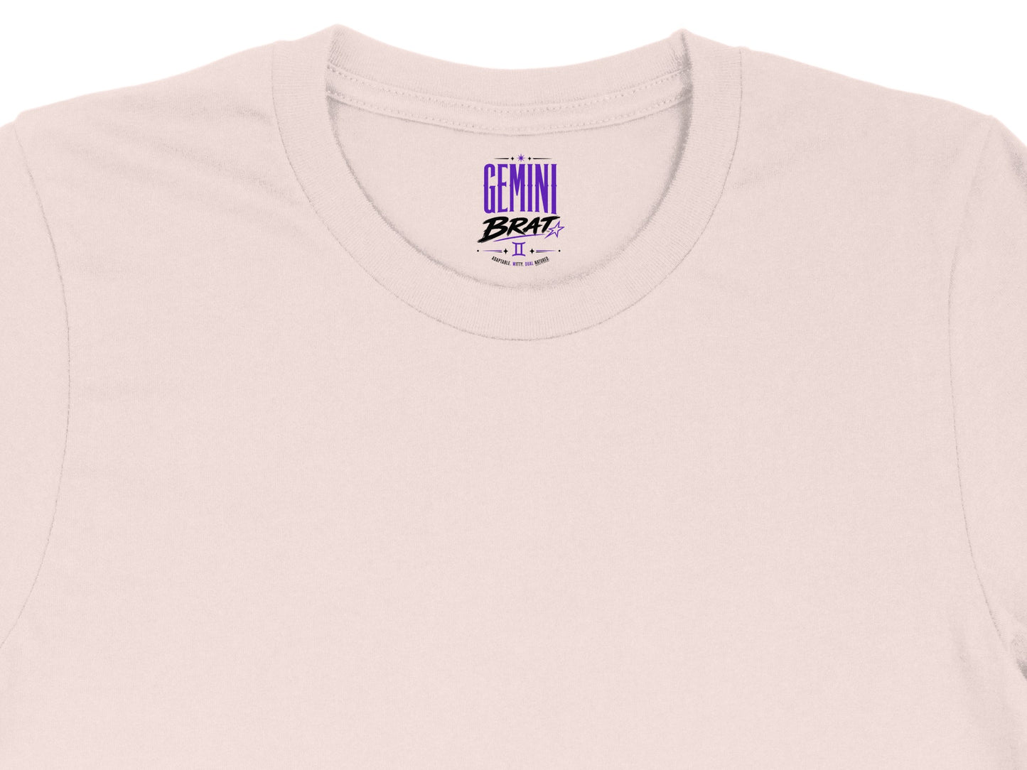 Light pink t-shirt with "Gemini Brat" graphic and astrological symbol.