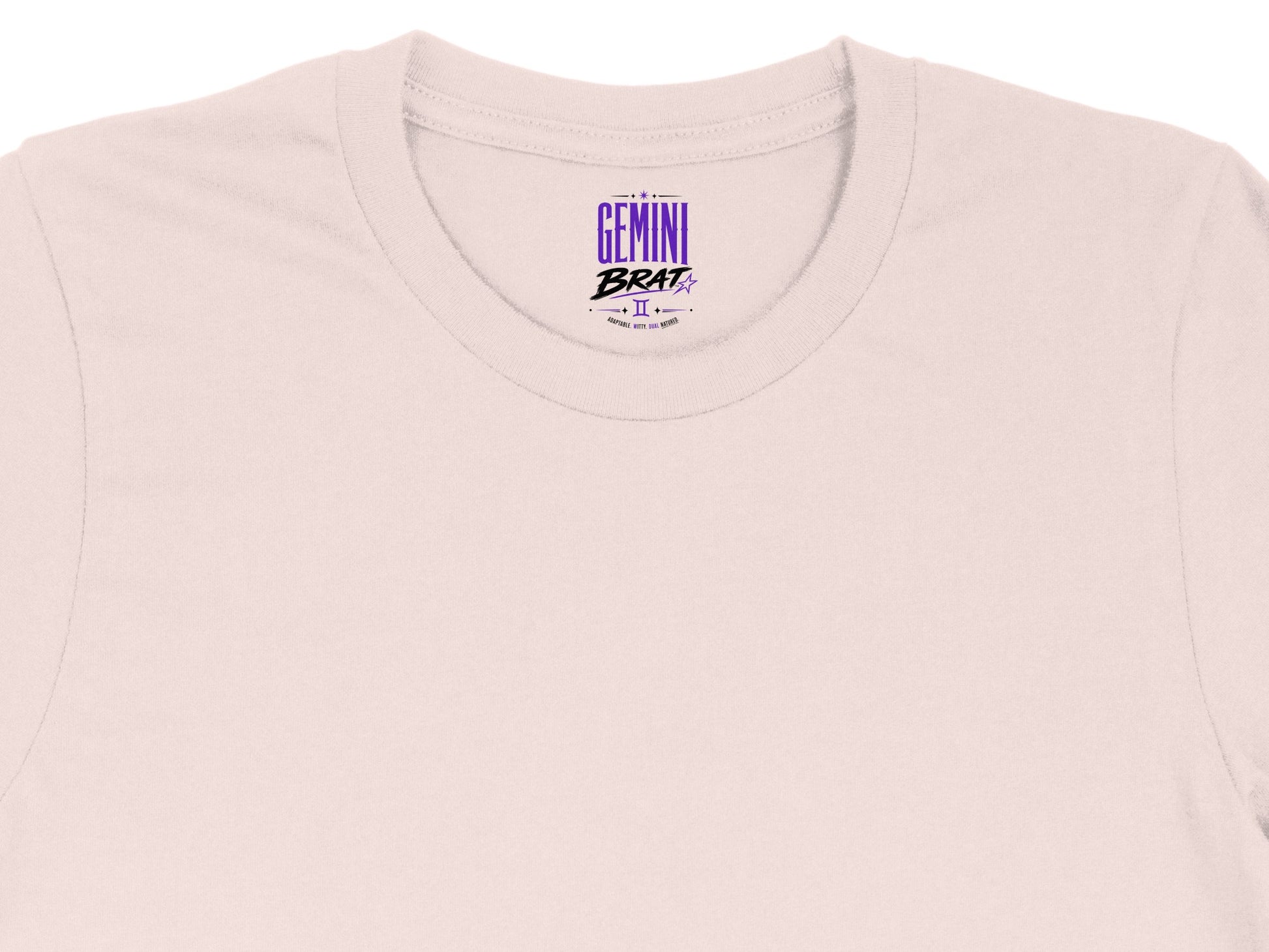 Light pink t-shirt with "Gemini Brat" graphic and astrological symbol.