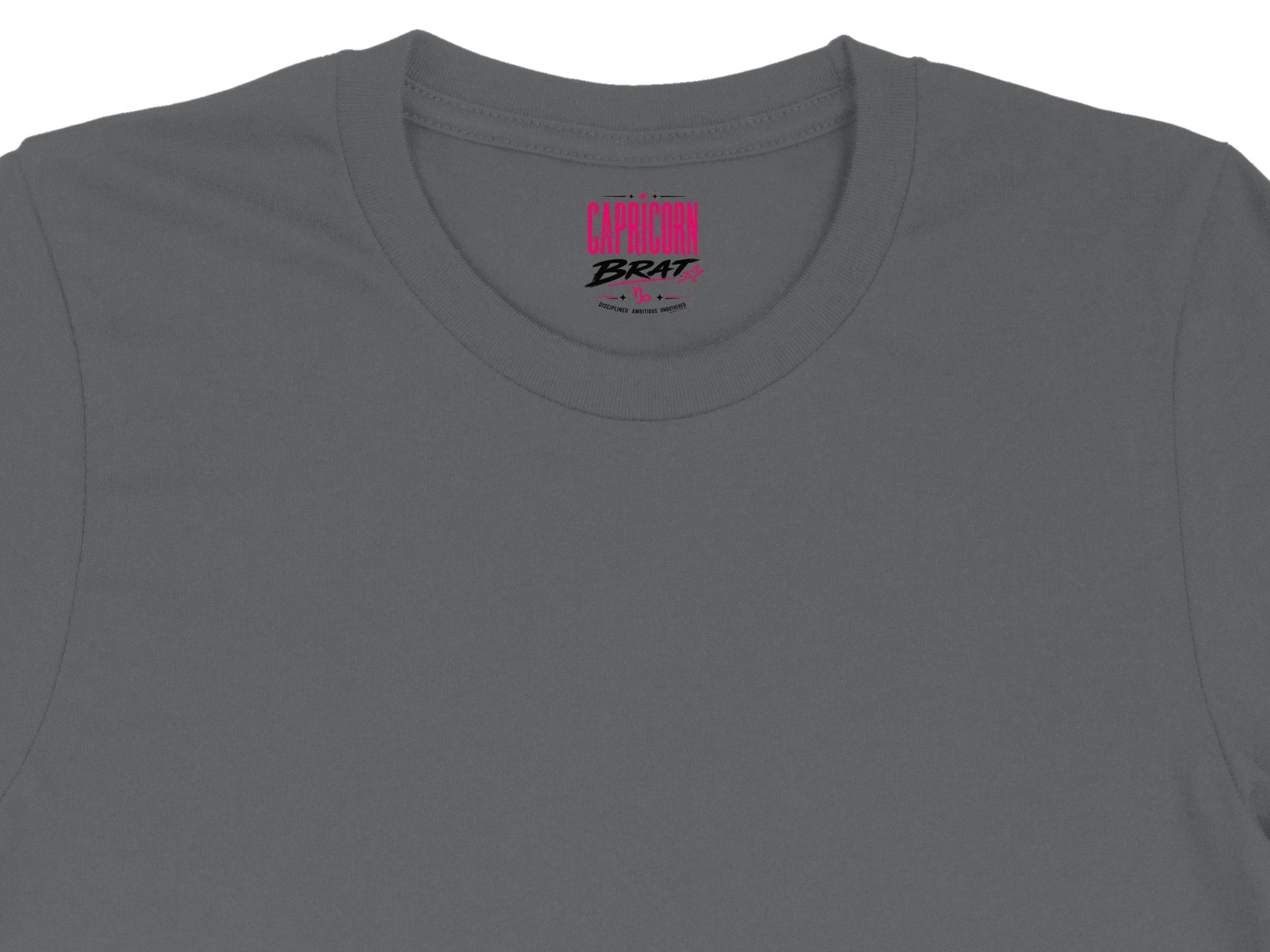 Capricorn Brat text with astrological symbols on a charcoal t-shirt collar.