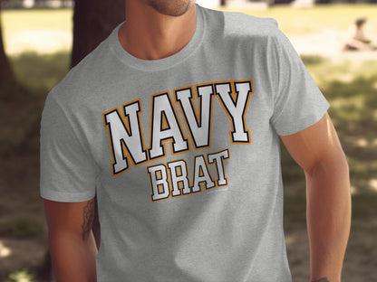 Grey t-shirt with "NAVY BRAT" text in white, navy, and orange lettering.