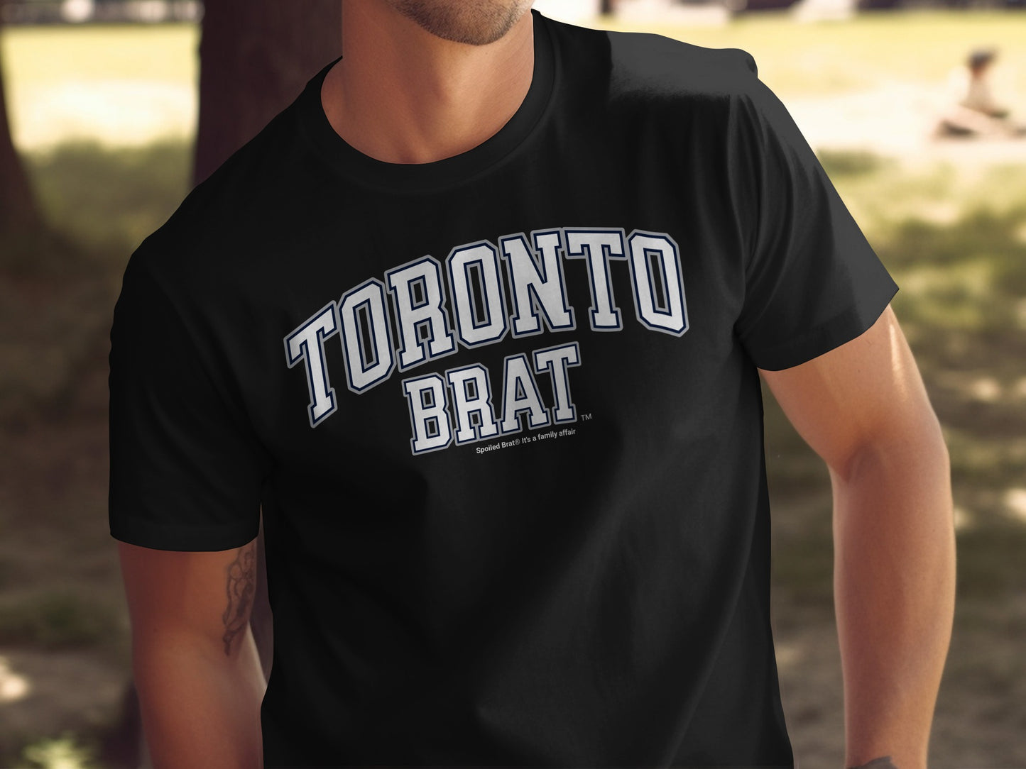 Black t-shirt with "TORONTO BRAT" arched text and "Spoiled Brat" small text.