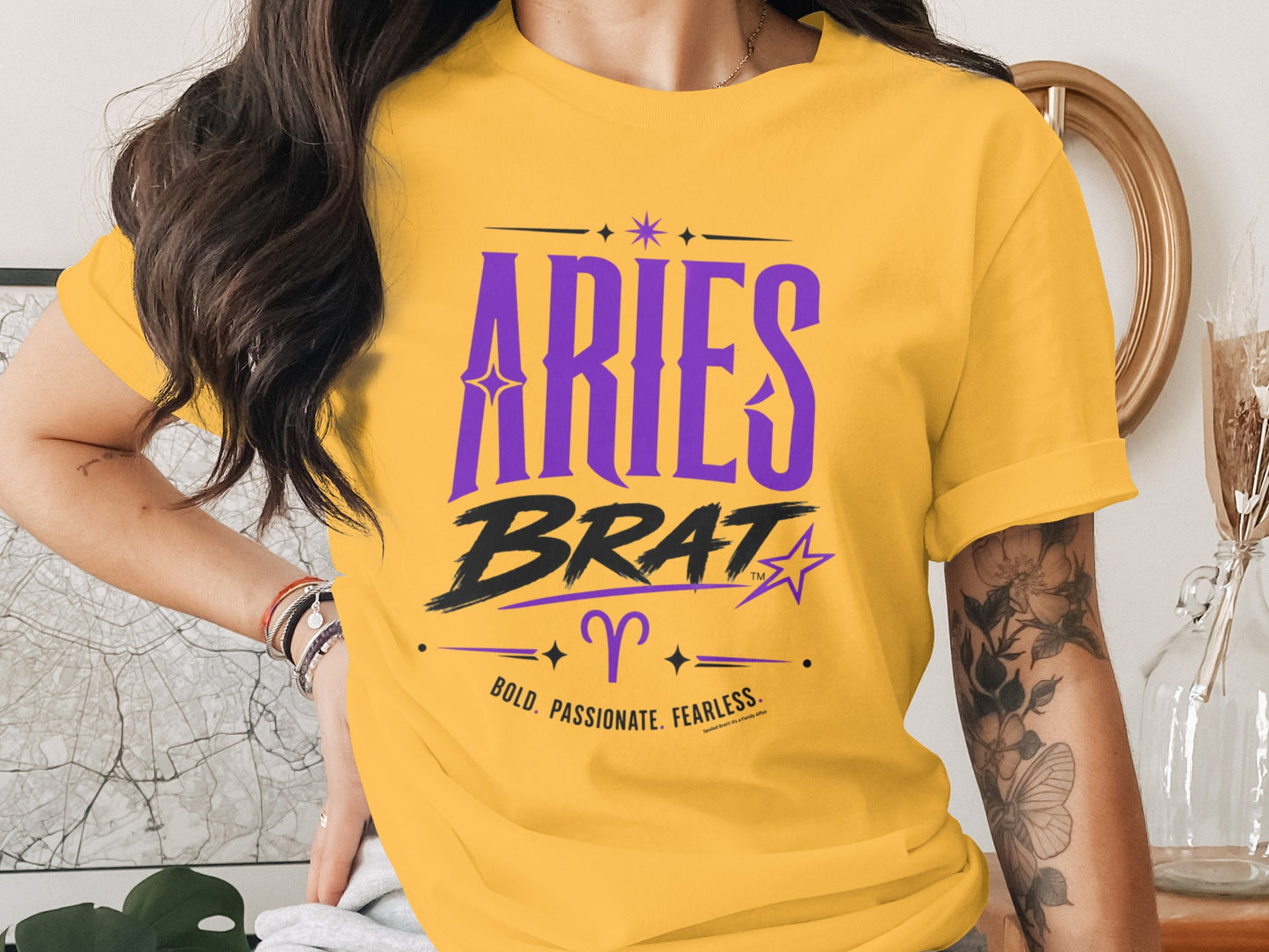 Yellow t-shirt with "Aries Brat" in purple and black, Aries symbol, and traits.