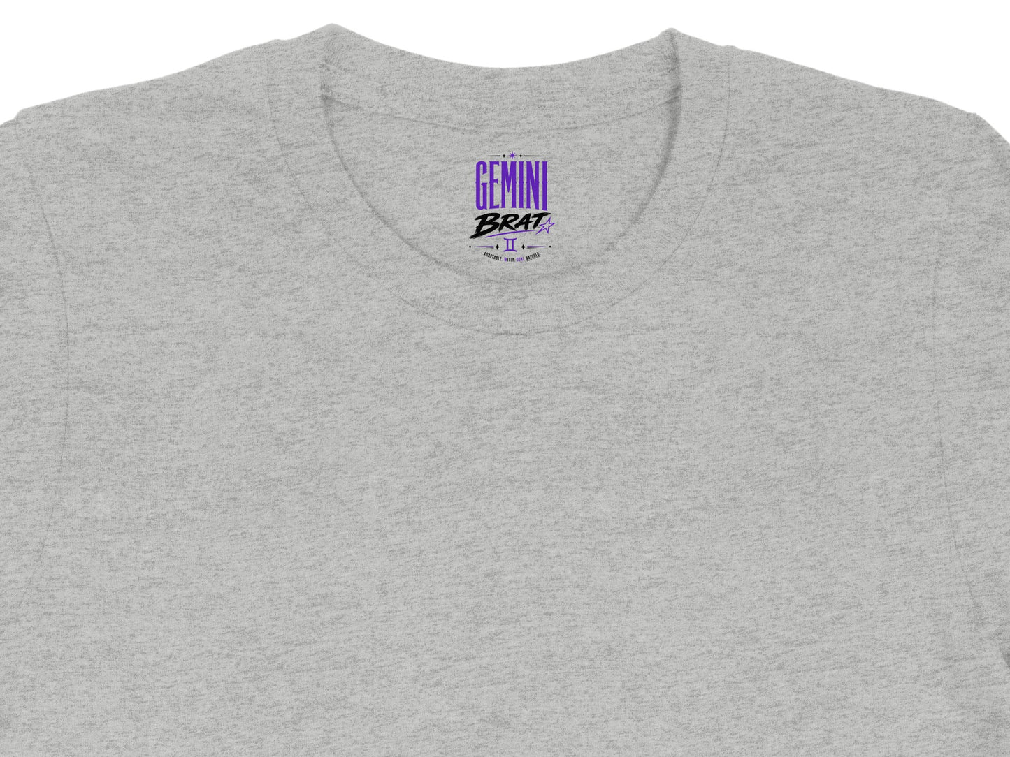 Grey t-shirt with purple "Gemini Brat" text and astrological symbol.