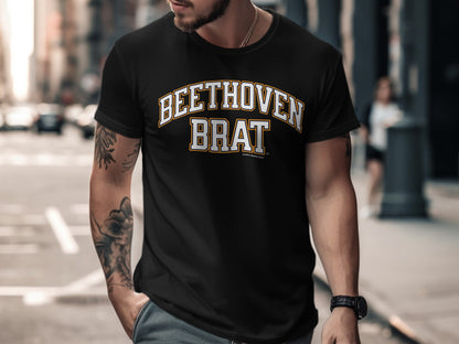 Black t-shirt with "BEETHOVEN BRAT" text in yellow and white varsity lettering.
