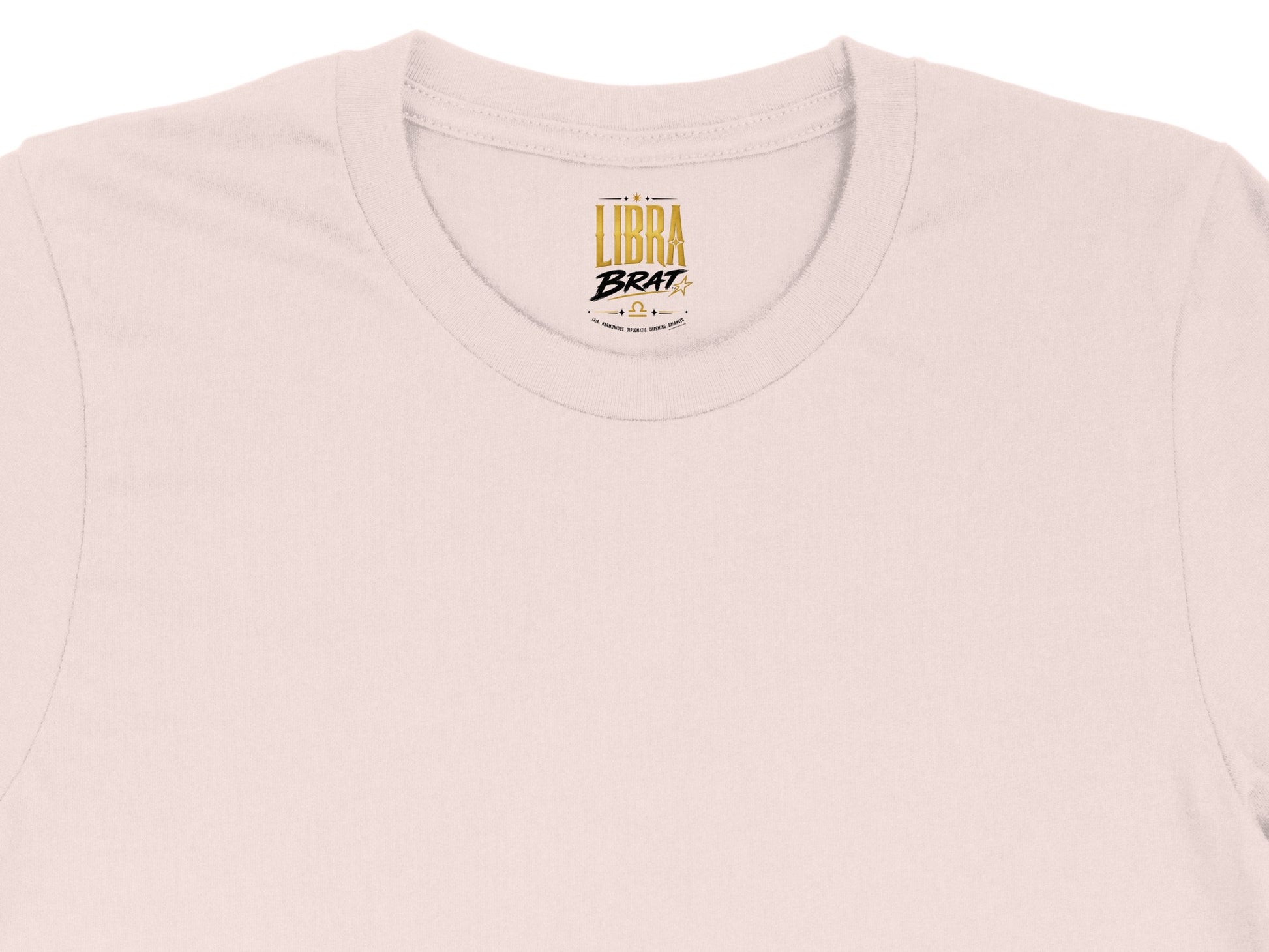 Pink t-shirt with gold "Libra Brat" logo and astrological symbols.