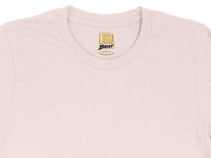 Pink t-shirt with gold "Libra Brat" logo and astrological symbols.