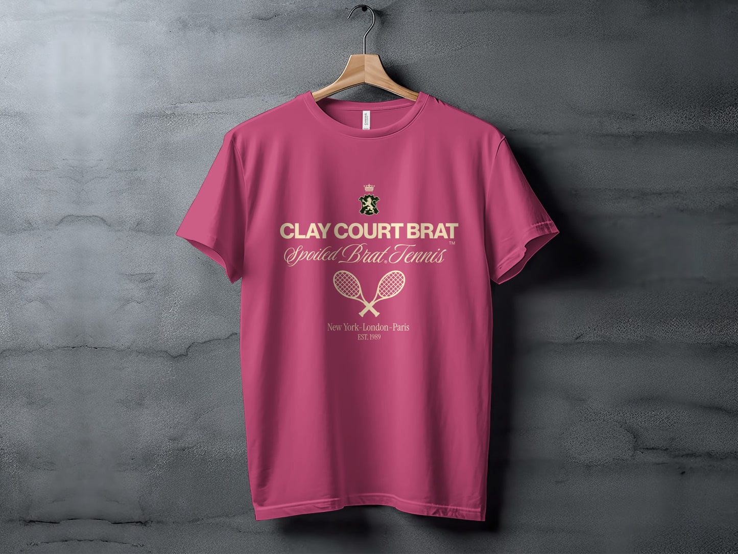 Pink t-shirt with "Clay Court Brat" and tennis rackets logo.