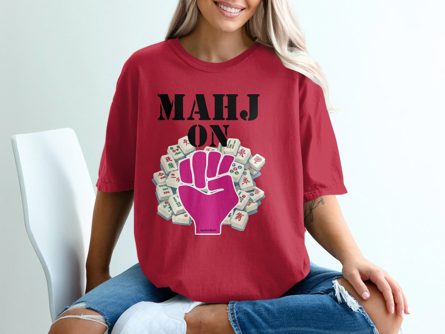 Red t-shirt with "MAHJ ON" text and a pink fist with mahjong tiles.