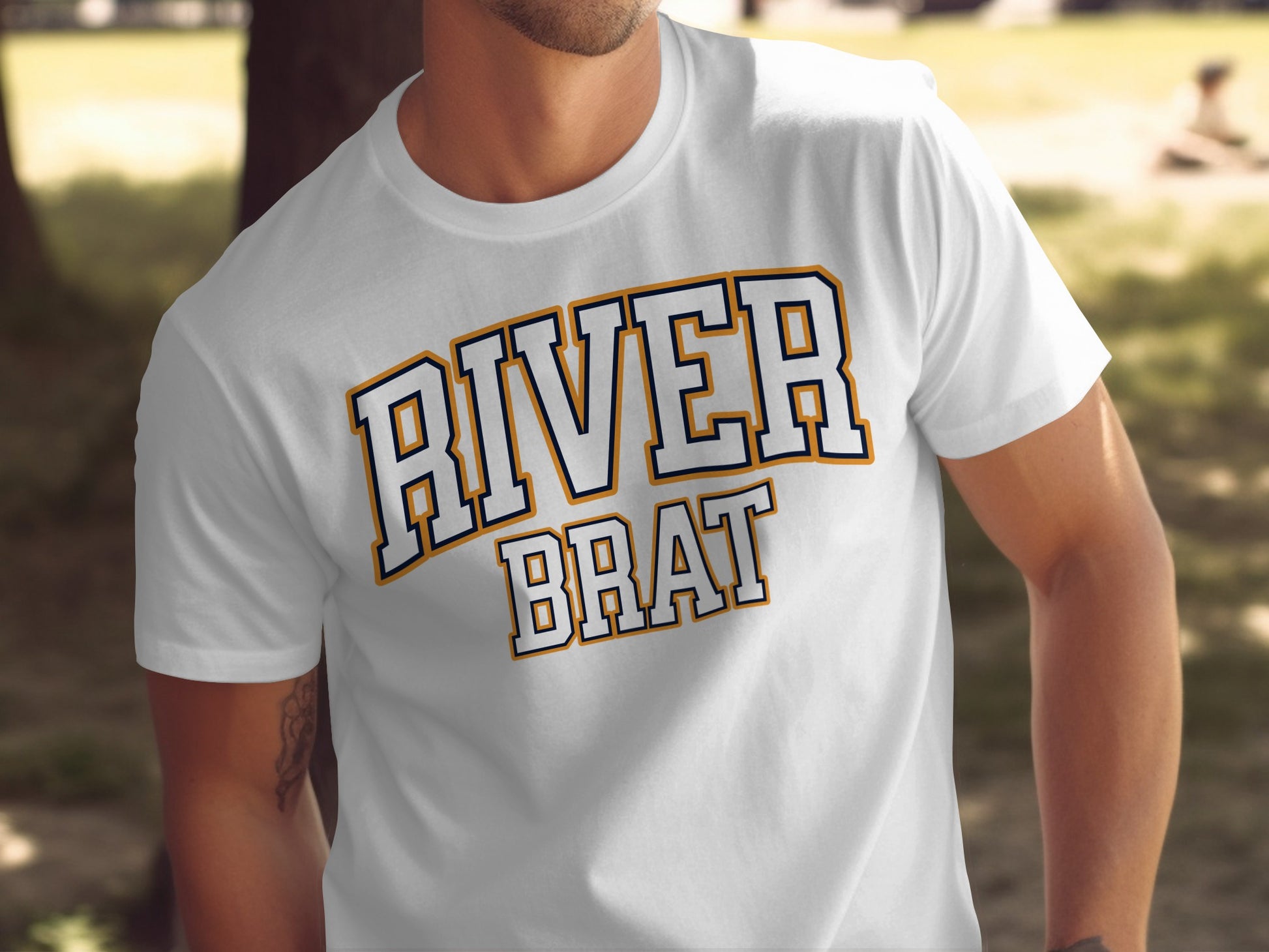 White t-shirt with "RIVER BRAT" text in collegiate varsity block lettering.