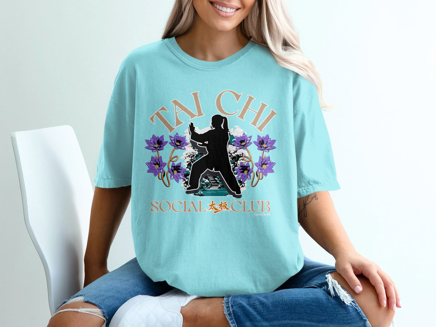 Light blue t-shirt with "Tai Chi Social Club" text and a silhouette of a Tai Chi practitioner.