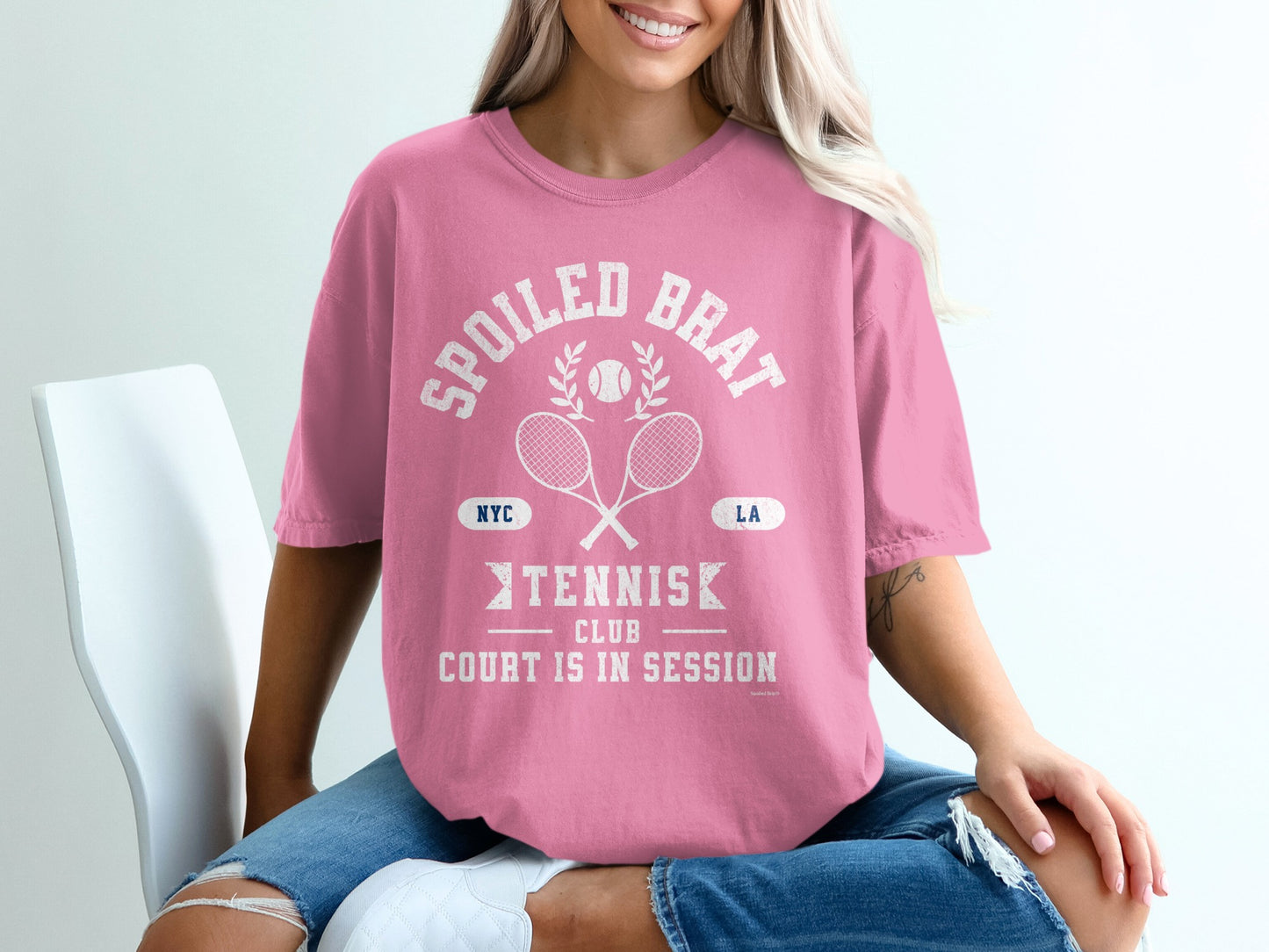 Pink t-shirt with "Spoiled Brat Tennis Club" text and crossed racquets.
