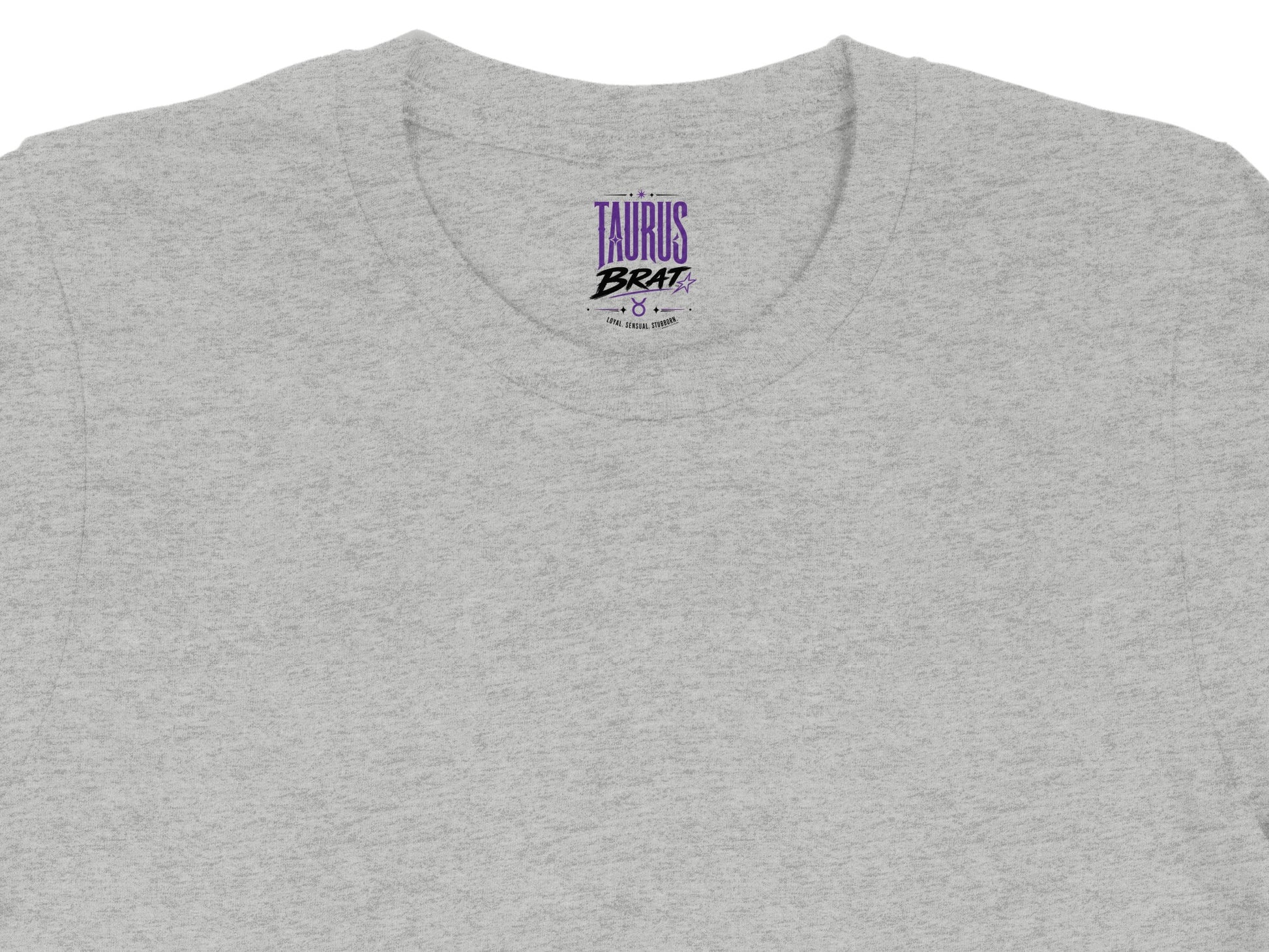 Grey t-shirt showing the inner label with "TAURUS BRAT" text and bull symbol.