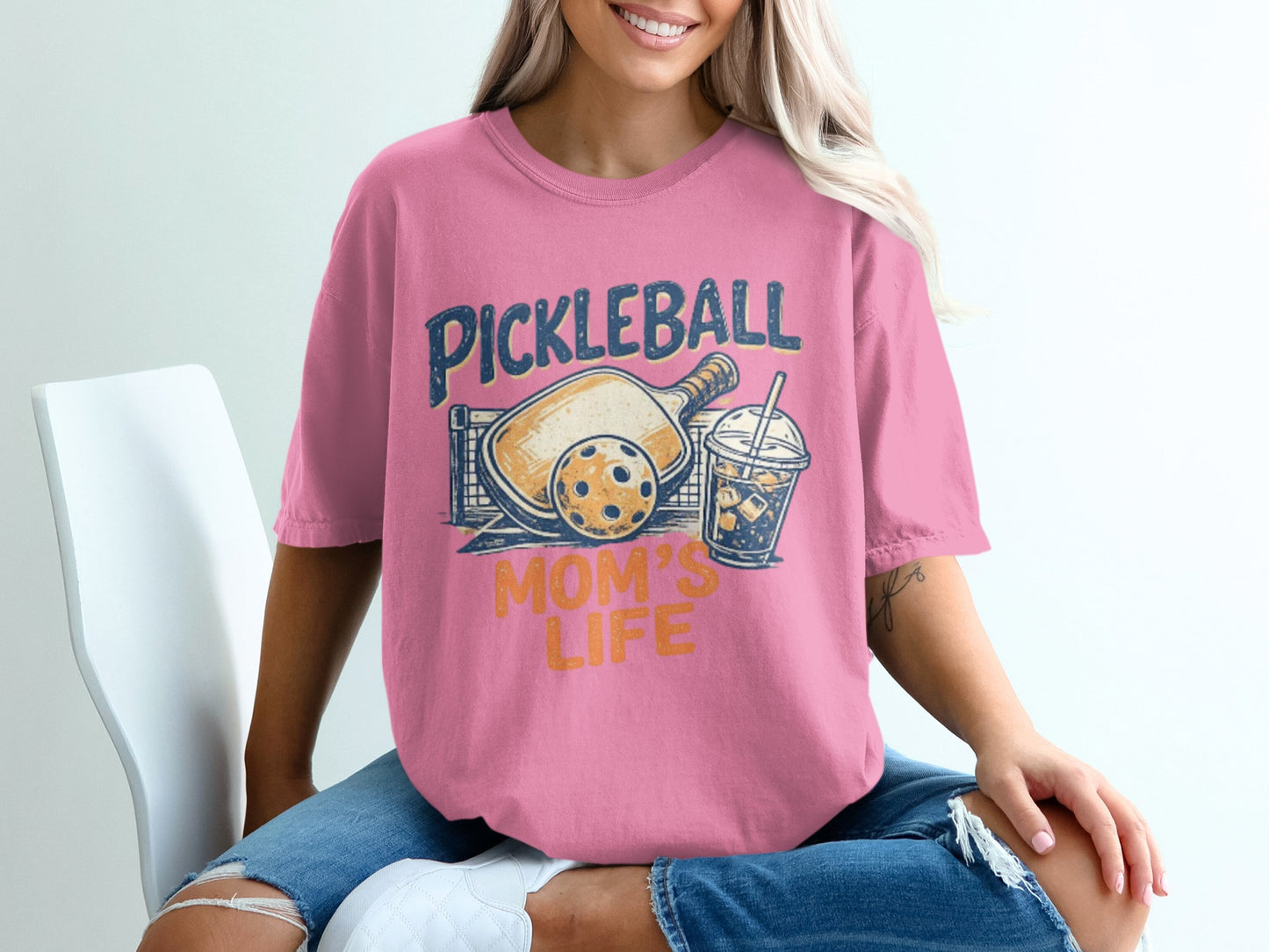 Pink t-shirt with "Pickleball Mom's Life" graphic featuring pickleball paddle, ball, and drink.