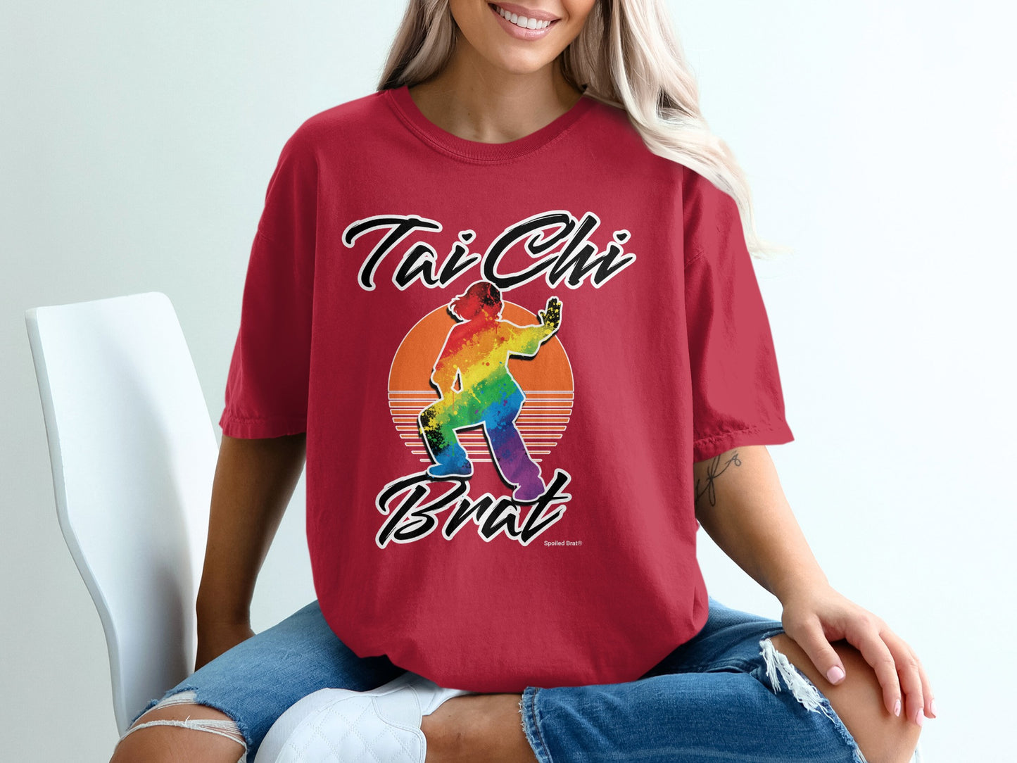 Red t-shirt with "Tai Chi Brat" text and rainbow silhouette of a person practicing Tai Chi.