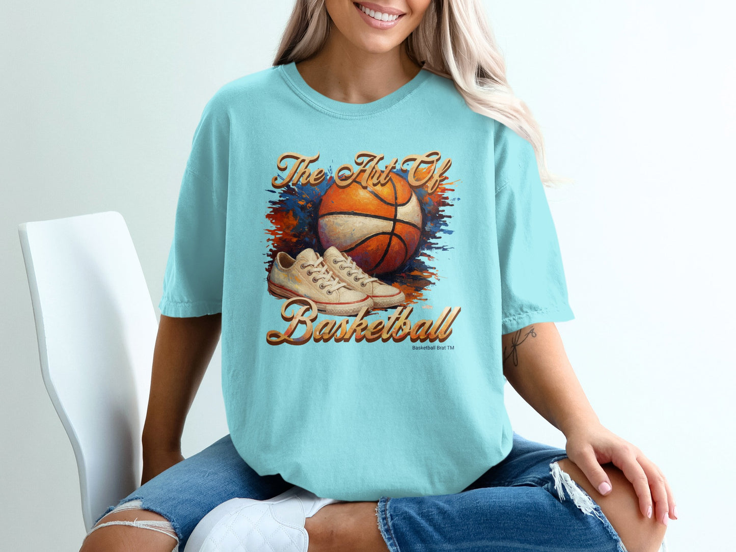 Light blue t-shirt with orange and blue basketball graphic and text.