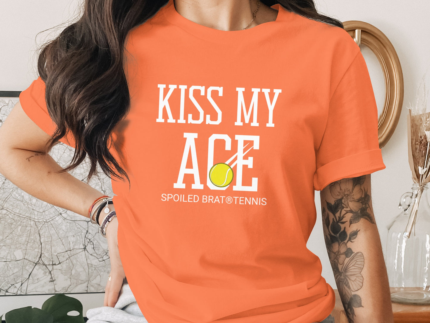Orange t-shirt with "KISS MY ACE" and tennis ball graphic.