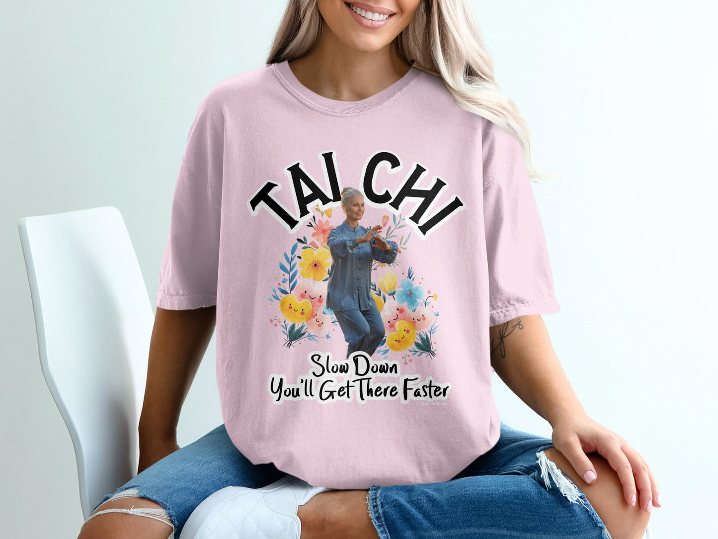 Pink t-shirt with "TAI CHI" and floral design with a woman in a Tai Chi pose.