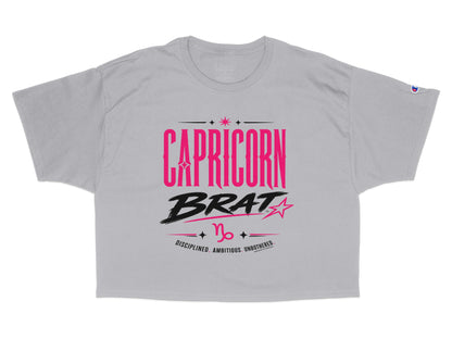 Grey t-shirt with "CAPRICORN BRAT" and zodiac symbol in pink and black.