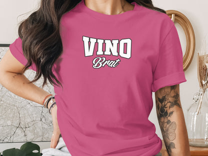 Pink t-shirt with "VINO Brat" graphic text on chest.