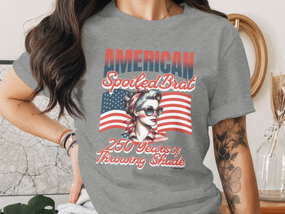 American Spoiled Brat graphic tee with patriotic woman and flag design.