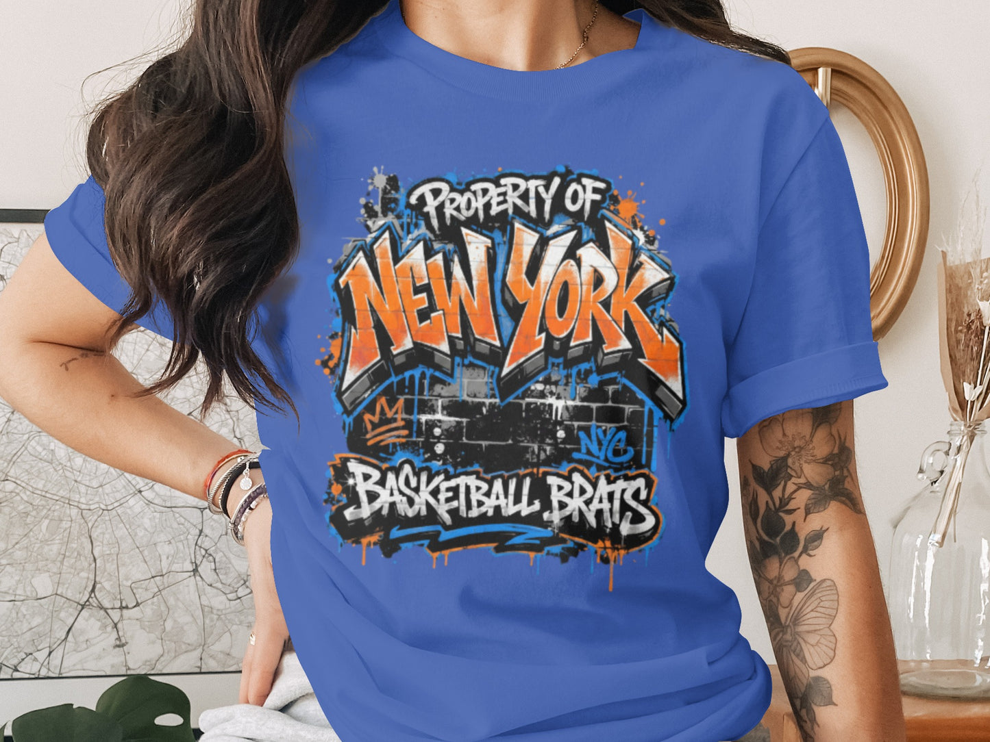Blue t-shirt with graffiti-style "Property of New York Basketball Brats" graphic.