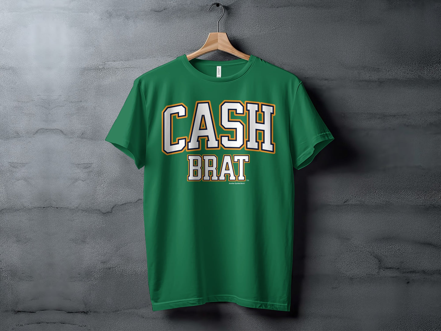 Green t-shirt with white and gold "CASH BRAT" text across the chest.
