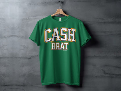 Green t-shirt with white and gold "CASH BRAT" text across the chest.