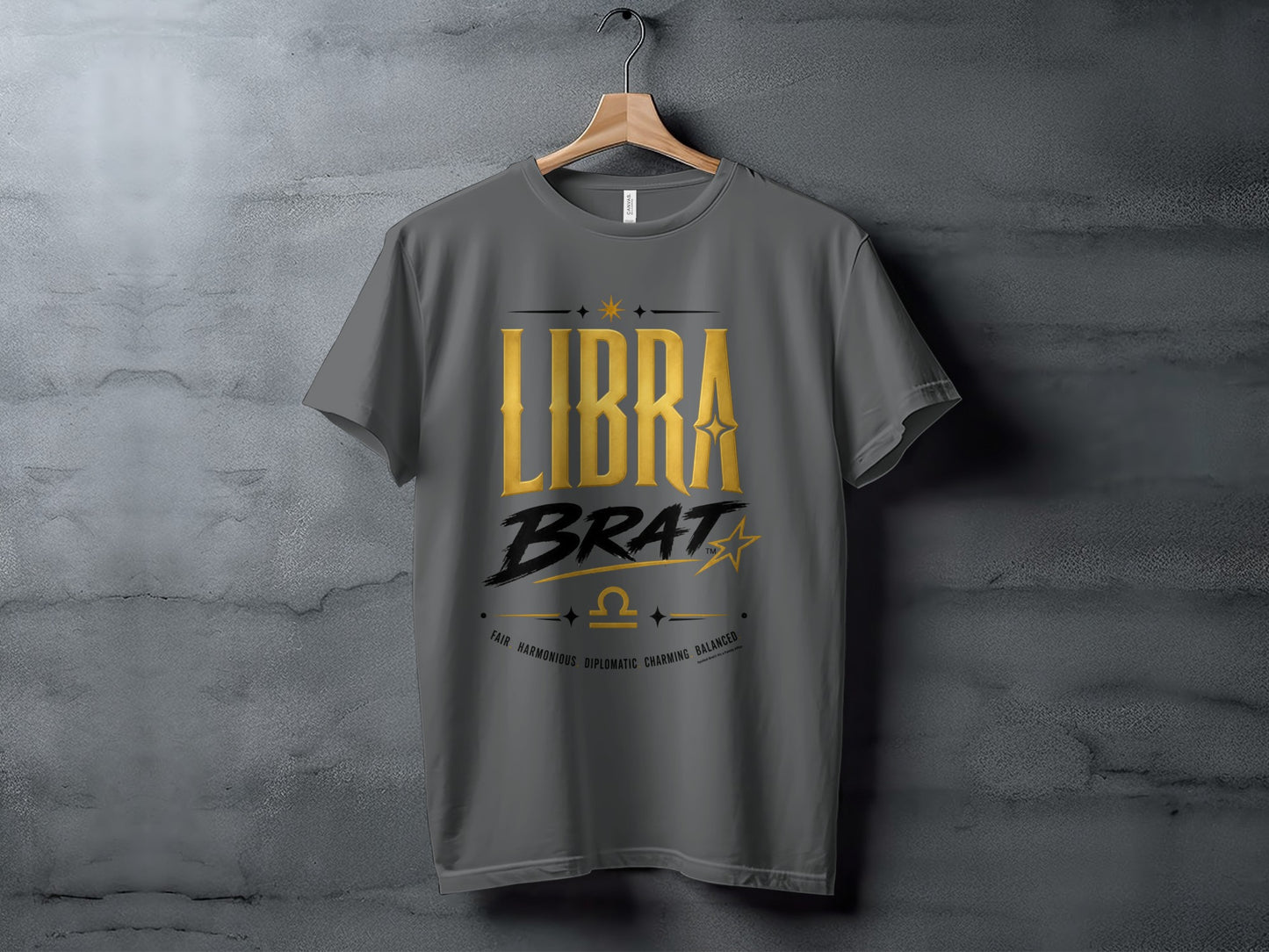 Gray t-shirt with gold text "LIBRA BRAT", Libra symbol, and descriptive words.