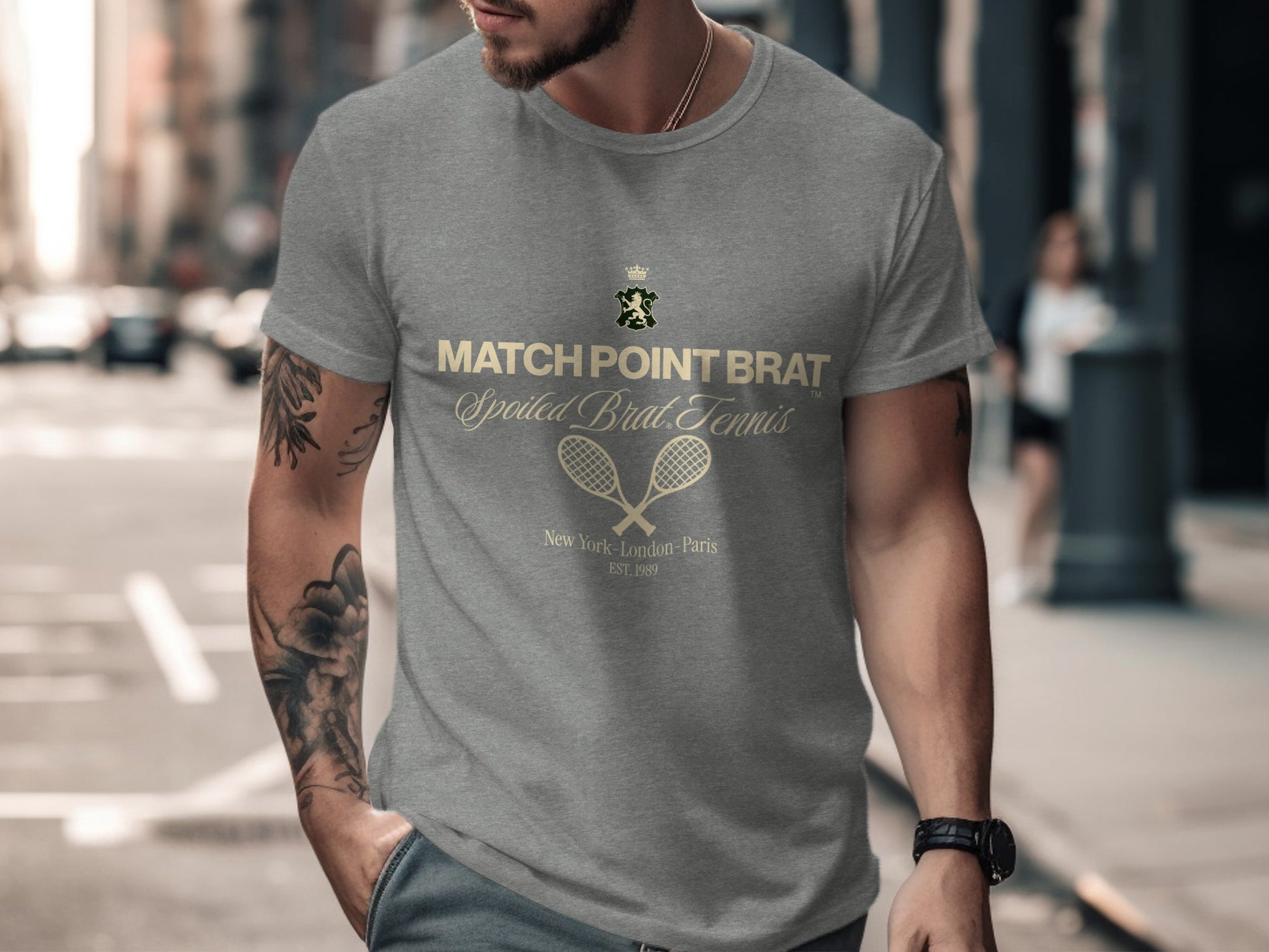 Grey t-shirt with "Match Point Brat" and tennis rackets graphic.