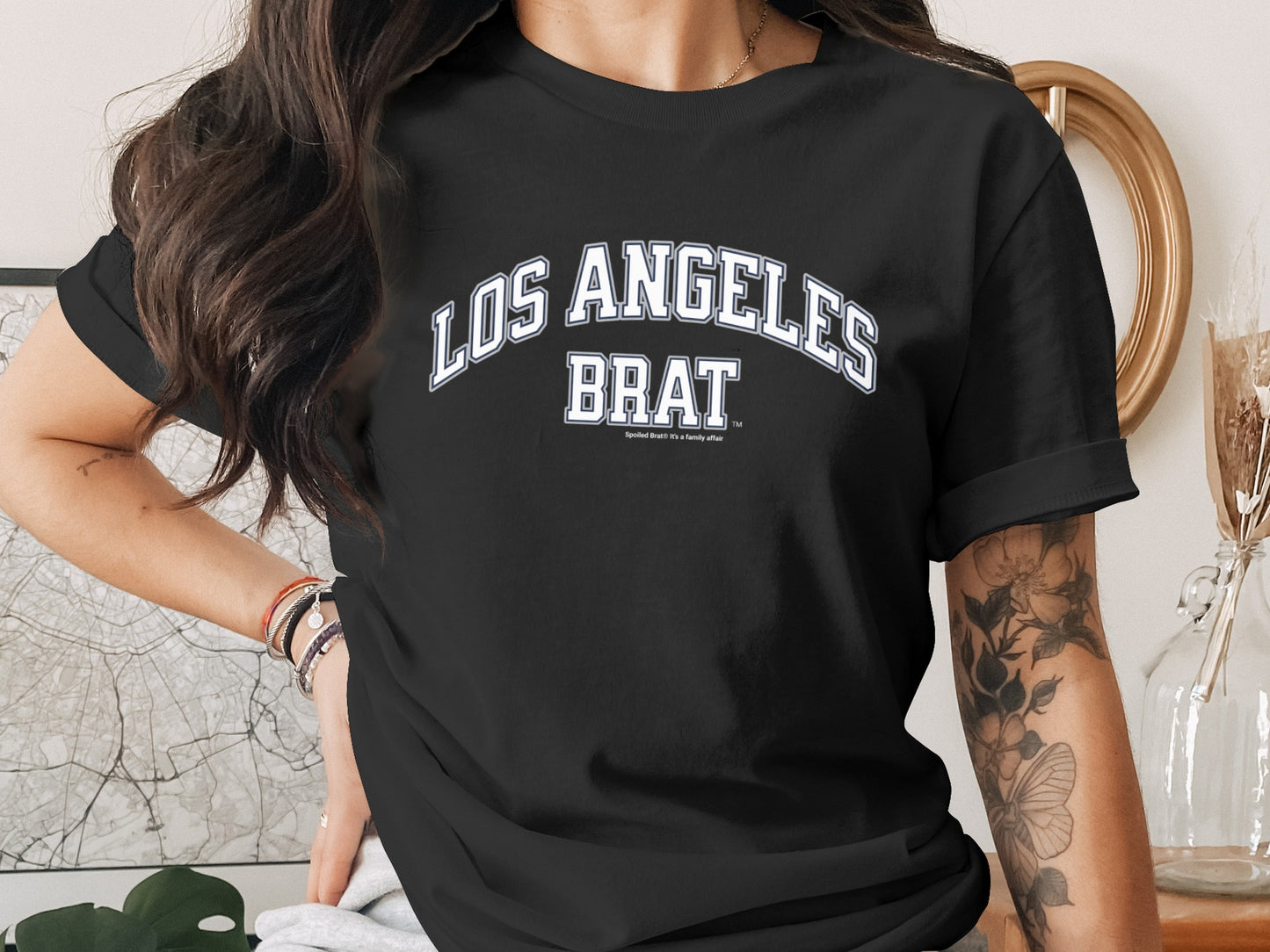 Black t-shirt with "LOS ANGELES BRAT" and "Always been a family affair" in white text.