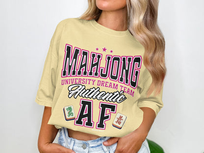 Cream t-shirt with "Mahjong University Dream Team Authentic AF" graphic.