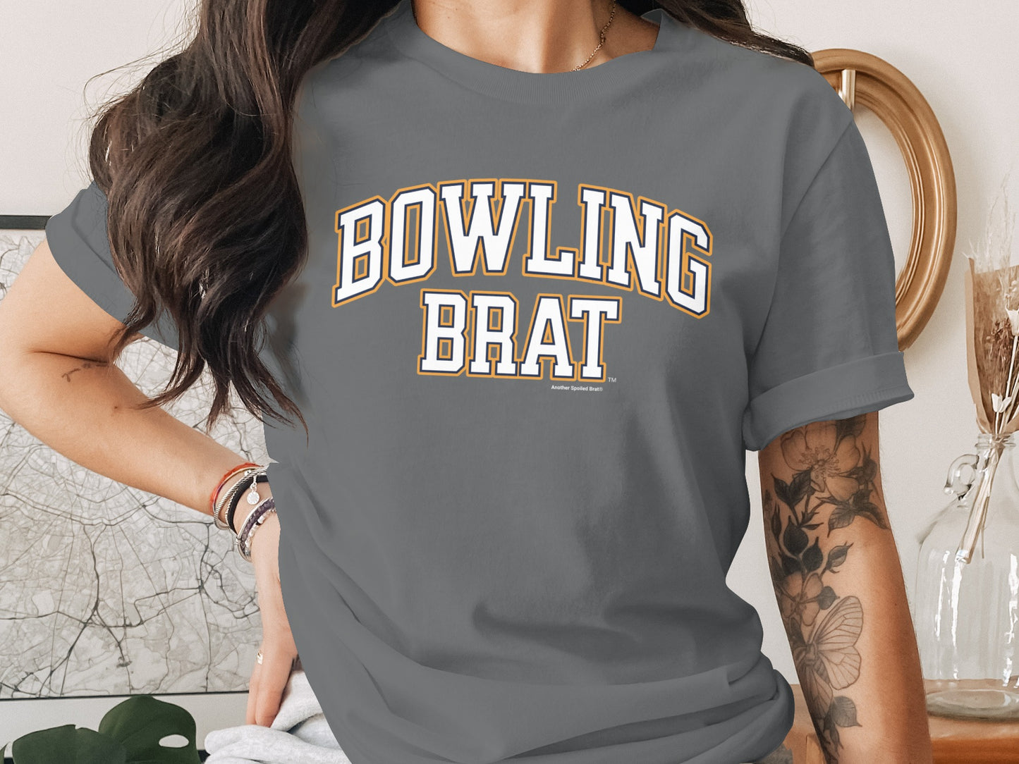 Gray t-shirt with white and orange "BOWLING BRAT" text in athletic font.