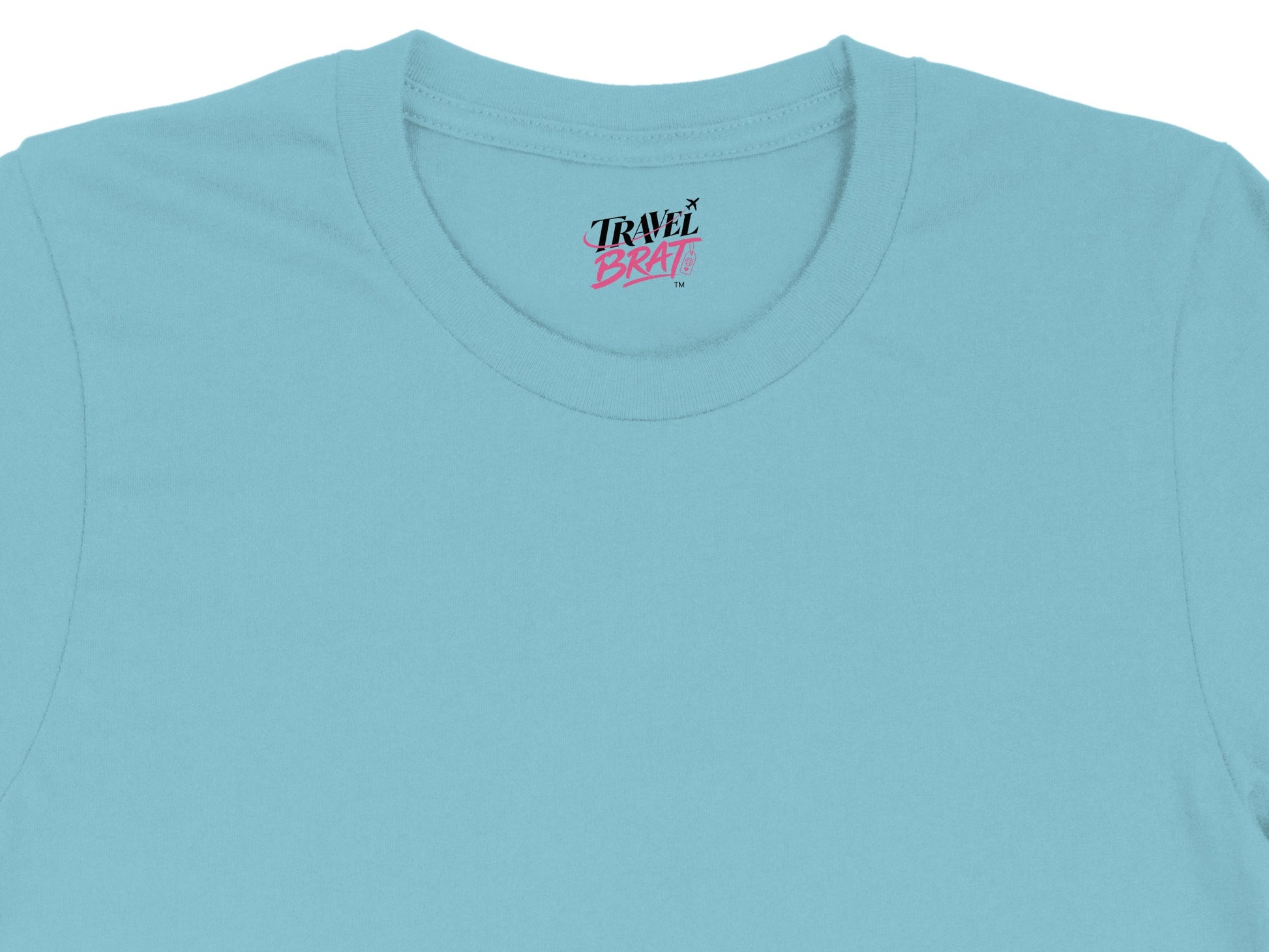 Blue t-shirt with "Travel Brat" logo and airplane graphic on collar label.