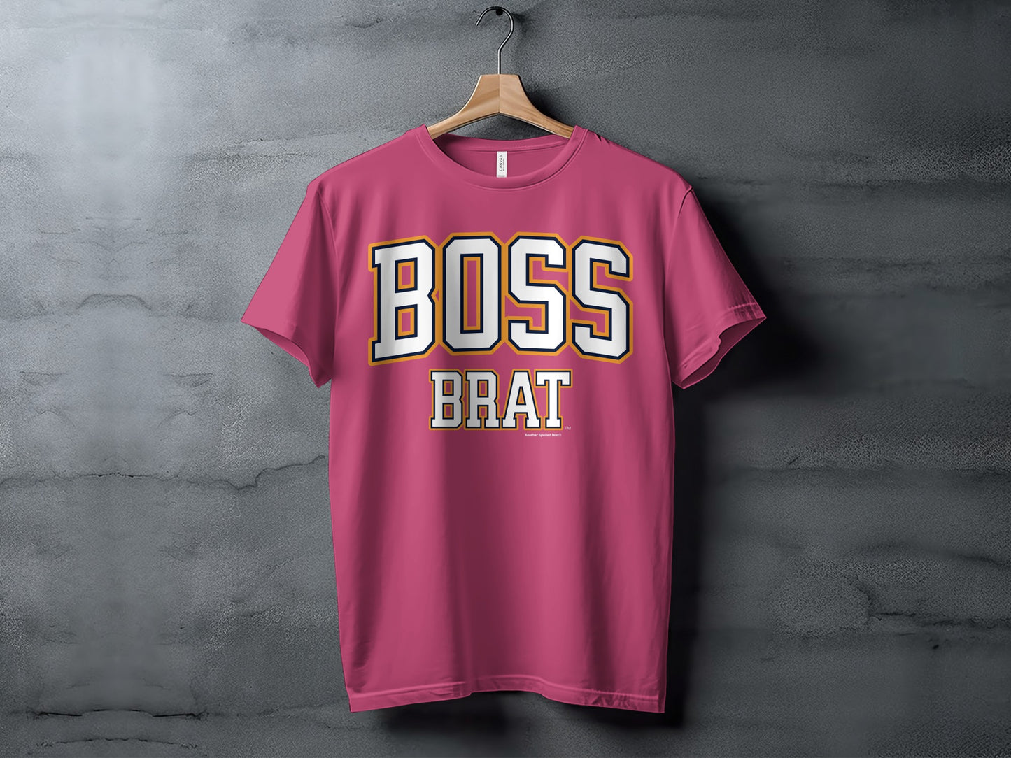Pink t-shirt with white and gold text reading "BOSS BRAT" and "Another Spoiled Brat" trademark.