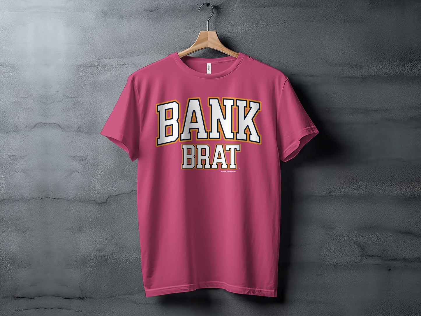 Pink t-shirt with "BANK BRAT" text in white outline and yellow trim.