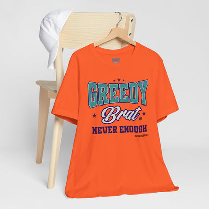 Orange t-shirt with "GREEDY Brat NEVER ENOUGH" text and stars.