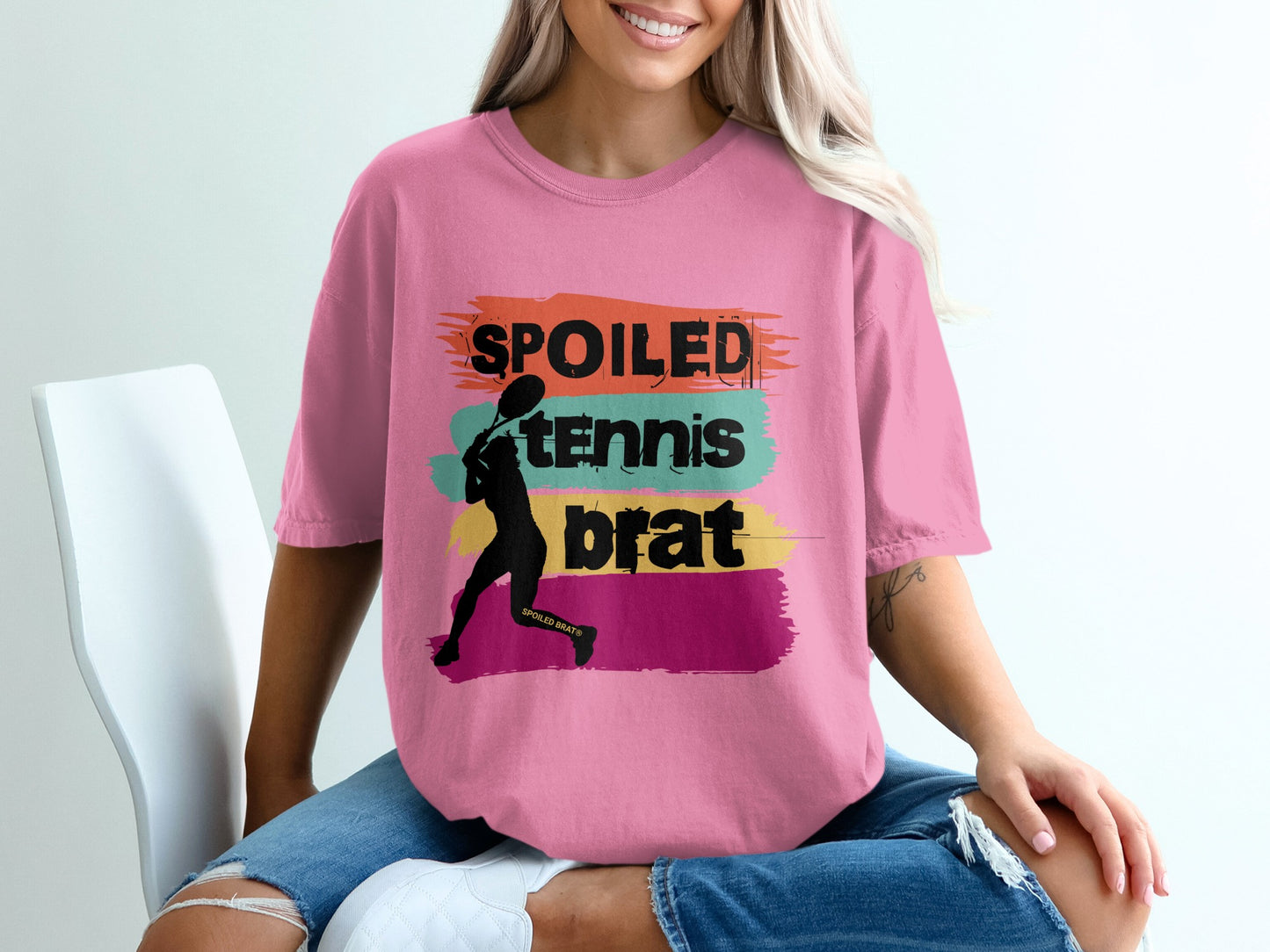 Pink t-shirt with "Spoiled Tennis Brat" graphic and tennis player silhouette.
