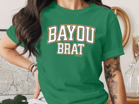Green t-shirt with white text "BAYOU BRAT" and a small "Another Spoiled Brat" label.