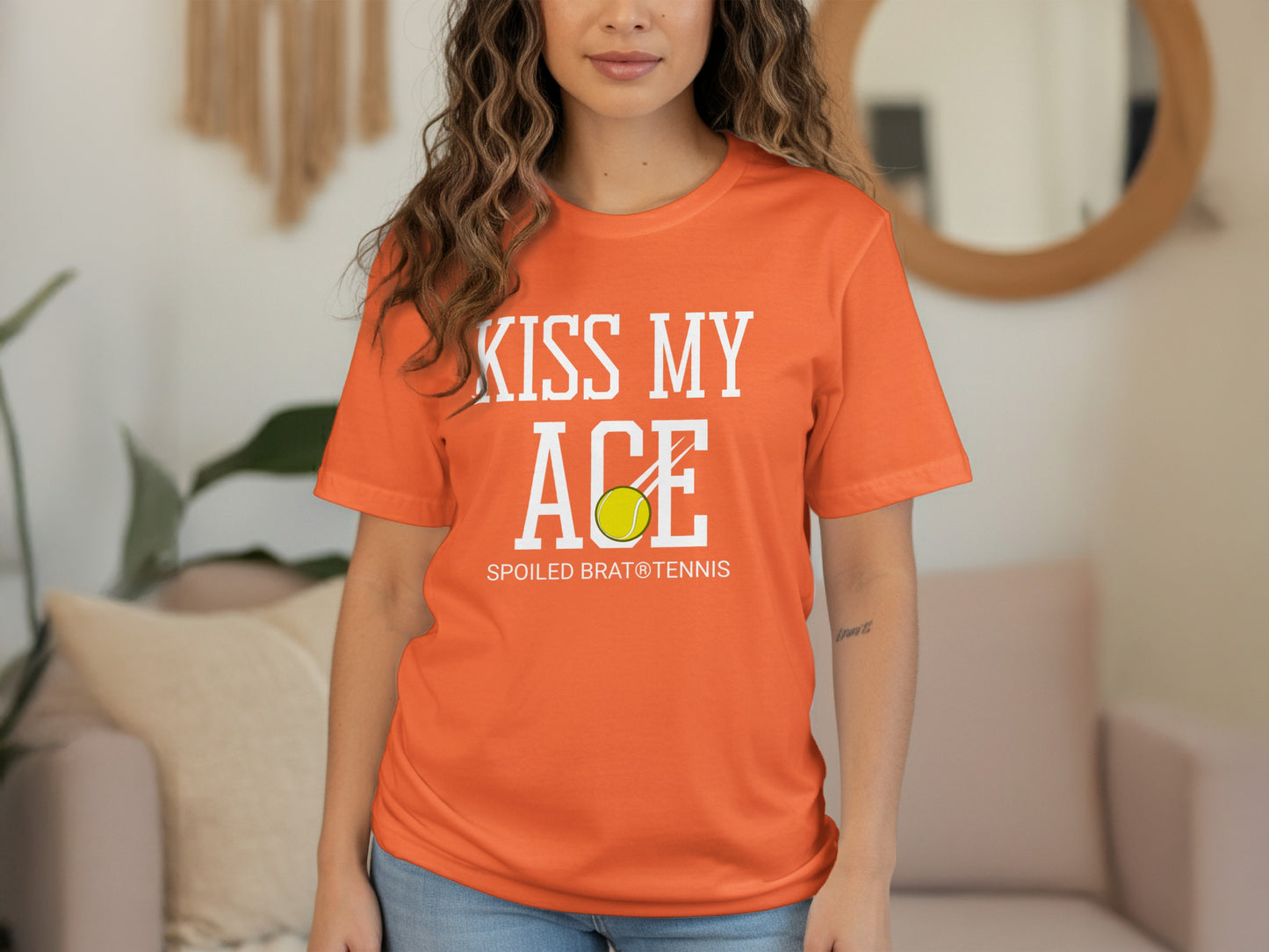Orange t-shirt with "Kiss My Ace Spoiled Brat Tennis" and a tennis ball.