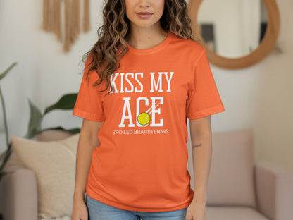 Orange t-shirt with "Kiss My Ace Spoiled Brat Tennis" and a tennis ball.