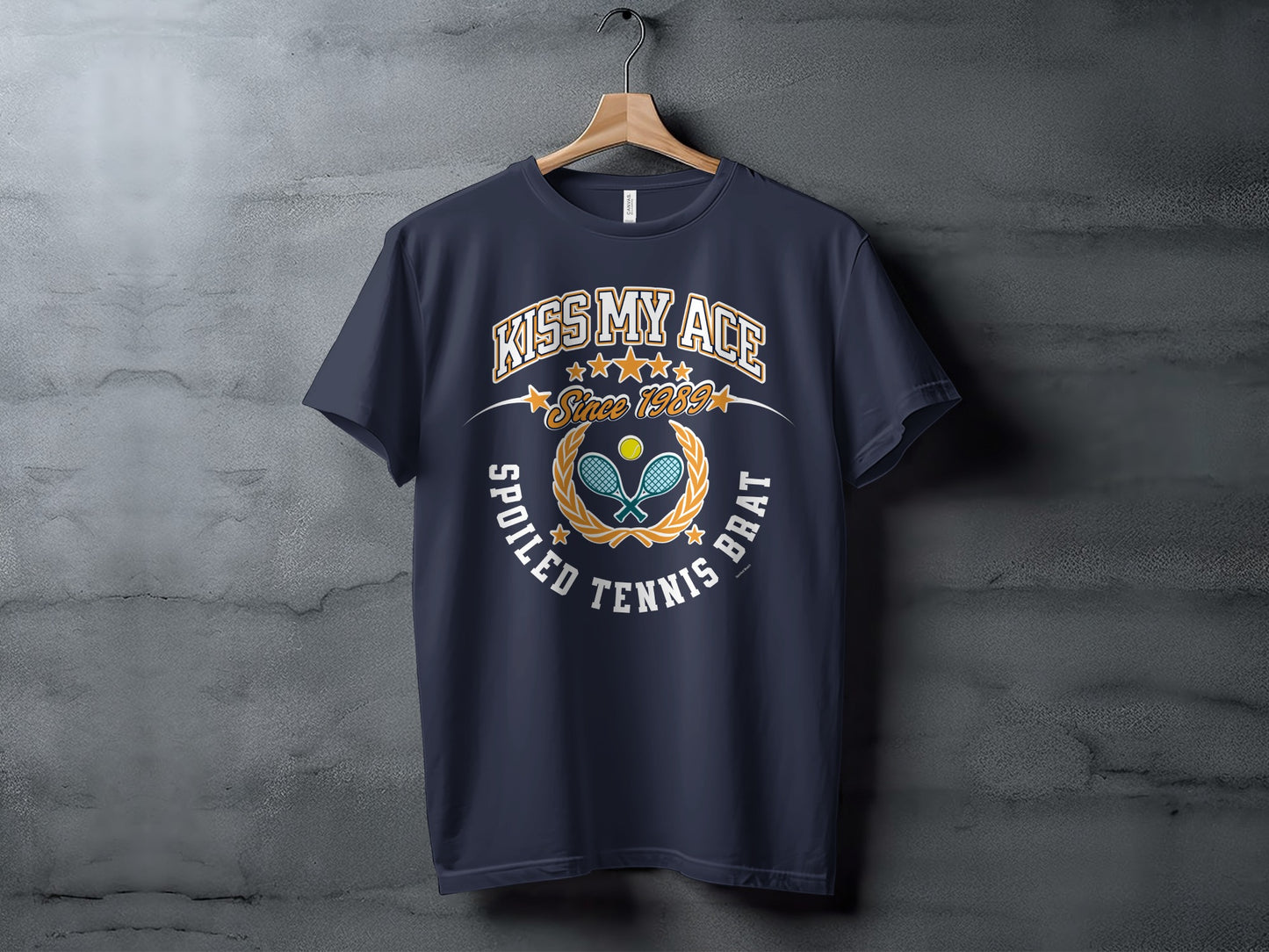 Navy t-shirt with "Kiss My Ace Since 1989 Spoiled Tennis Brat" text and graphic.