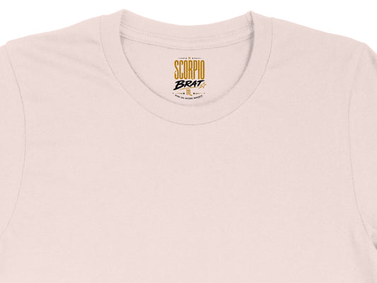 Light pink t-shirt with "Scorpio Brat" logo and zodiac symbol.