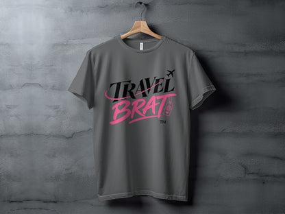 Gray t-shirt with the text "TRAVEL BRAT" in black and pink script.