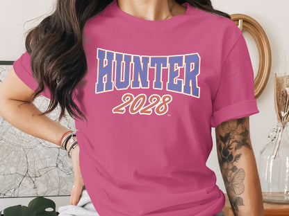 Pink t-shirt with bold blue "HUNTER" and orange "2028" text.