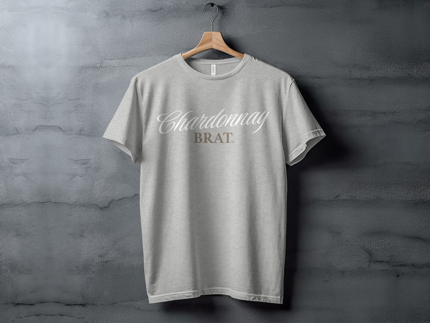 Light grey t-shirt with "Chardonnay BRAT" text on a hanger.