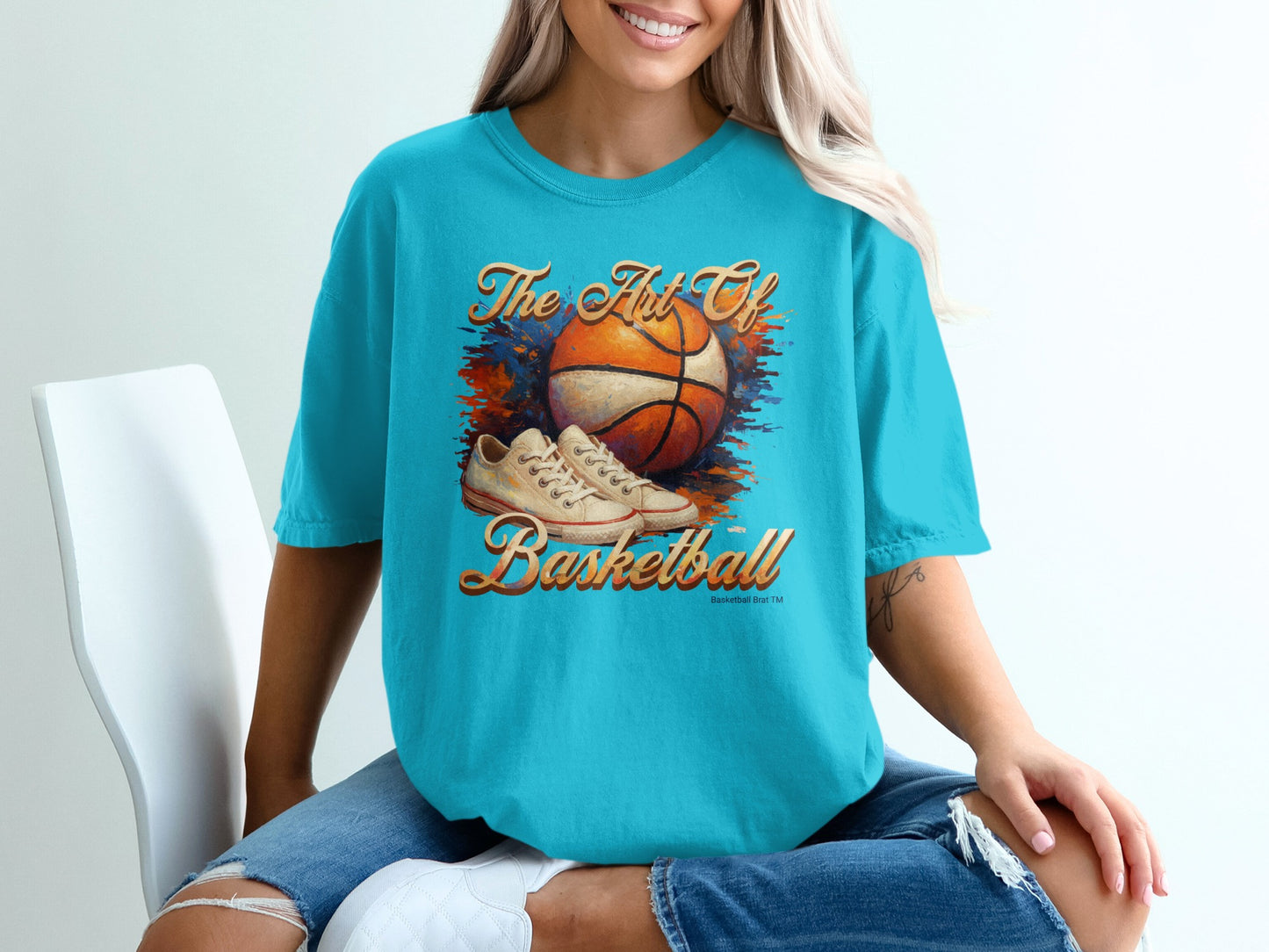 Turquoise t-shirt with "The Art of Basketball" graphic and basketball shoes.