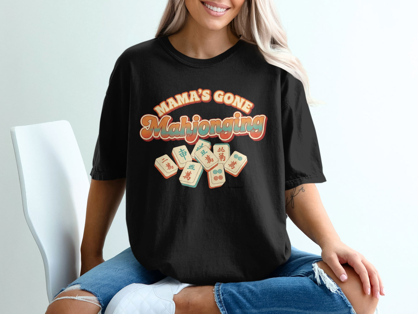 Black t-shirt with "Mama's Gone Mahjong" in retro lettering and Mahjong tiles.