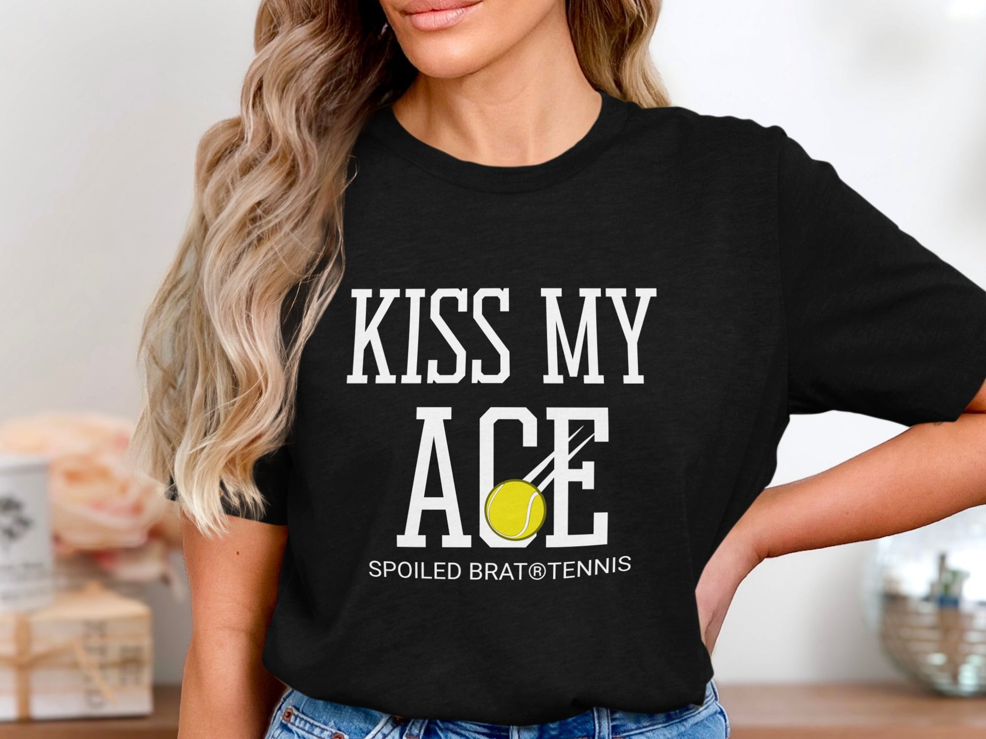 T-shirt with text "KISS MY ACE" and a tennis ball.