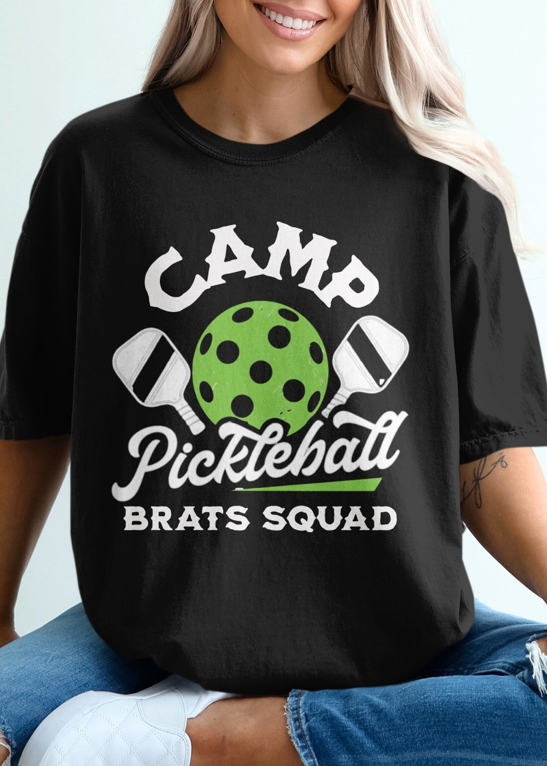 Black t-shirt with "Camp Pickleball Brats Squad" text and pickleball graphic.